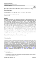 Wake Characterization of Building Clusters Immersed in Deep Boundary Layers